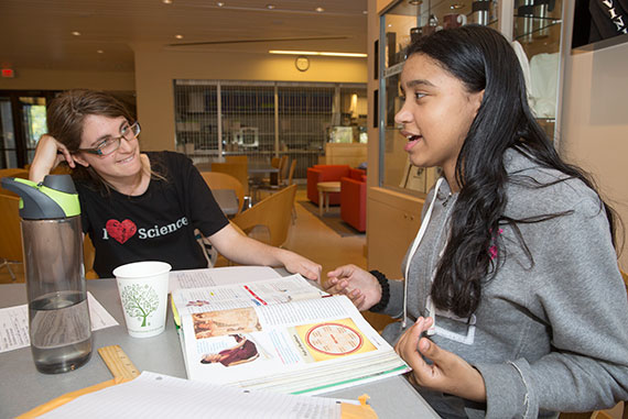 Gabby Goodman, HDS ’16 (left), tutors Gabby Mata-Torres, a seventh-grader. / Photo: Jon Chase, Harvard Staff Photographer