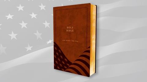 A Bible in front of a gray American flag