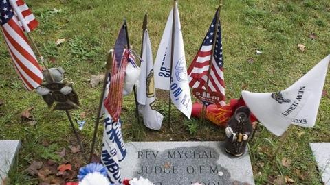 Flags and other items surround the grave where Franciscan Father Mychal F. Judge, a chaplain of the New York Fire Department, is buried at Holy Sepulchre Cemetery in Totowa, New Jersey.
